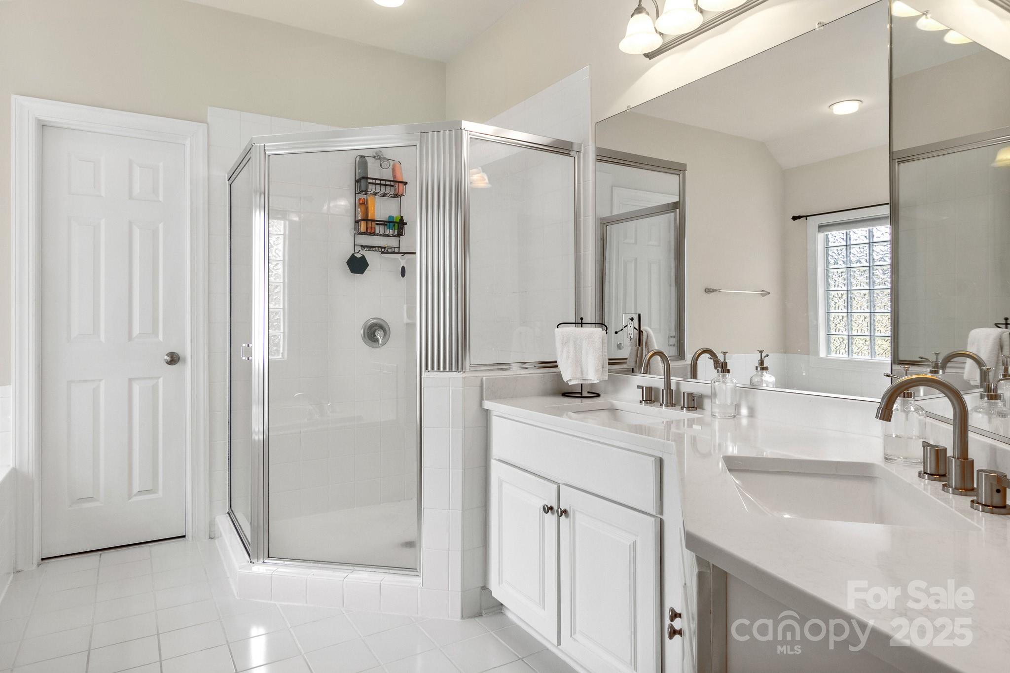 191 Melbourne Drive Fort Mill, SC 29708 - Photo 21 of 35 a bathroom with a double vanity sink mirror and shower
