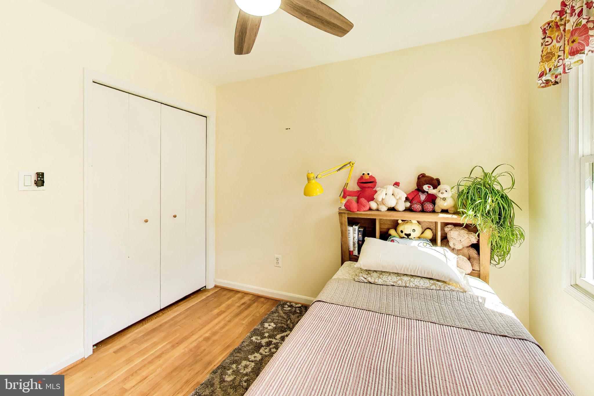 14216 Alderton Road Silver Spring, MD 20906 - Photo 25 of 63 a bedroom with a bed table and a potted plant