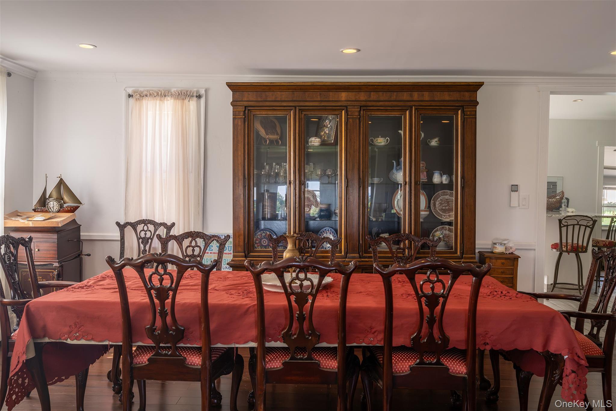 40495 Main Road Orient, NY 11957 - Photo 10 of 26 Expansive dining room between the front living room and large farmhouse kitchen behind. Floors are amazing and the updates keep the original wood details showing the charm and character of this classic architecture.