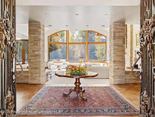 a living room with fireplace furniture and a rug