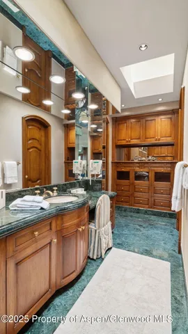 a bedroom with a large bed and a night stand