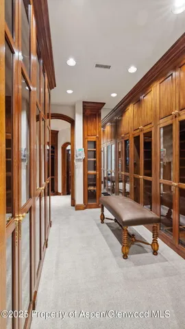 a bedroom with a bed and a large mirror