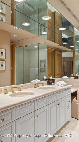 a living room with furniture a large window and a potted plant