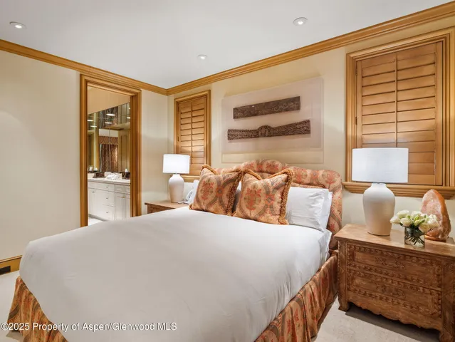 a bedroom with a bed and a lounge chair