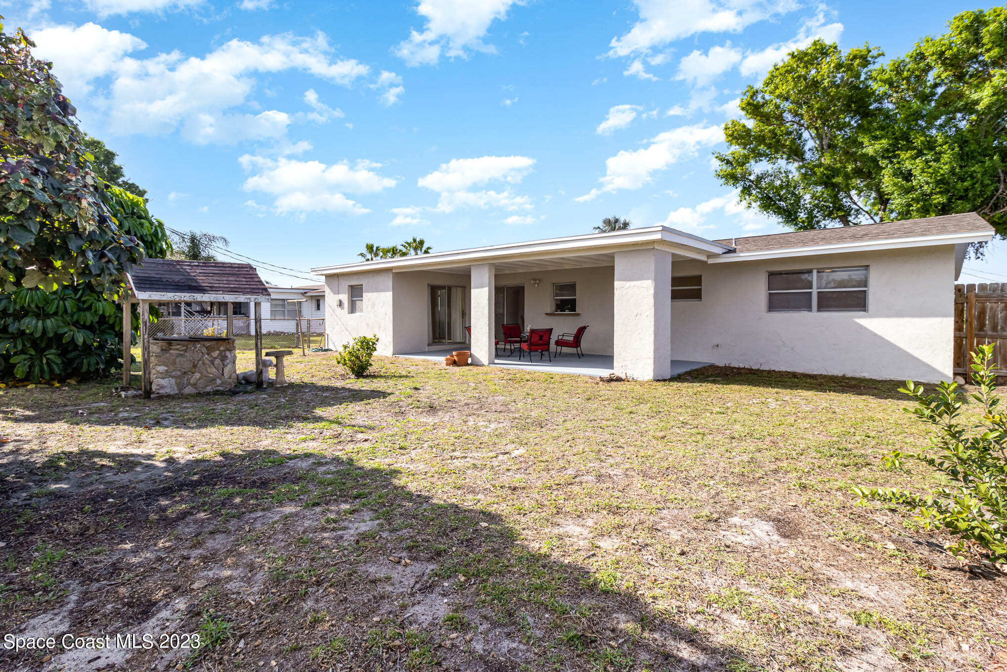 2095 Montgomery Road Melbourne, FL 32935 - Photo 5 of 25 a view of a house with backyard and trees