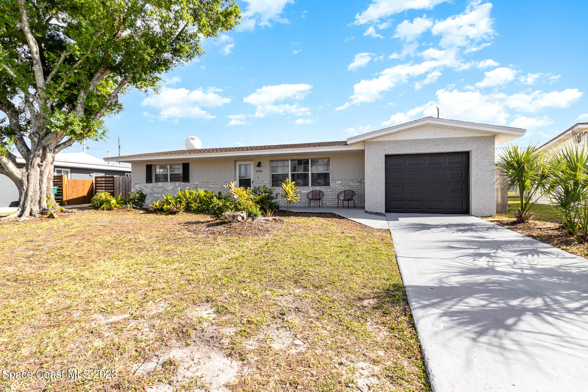 2095 Montgomery Road Melbourne, FL 32935 - Photo 6 of 25 a front view of a house with a yard and potted plants