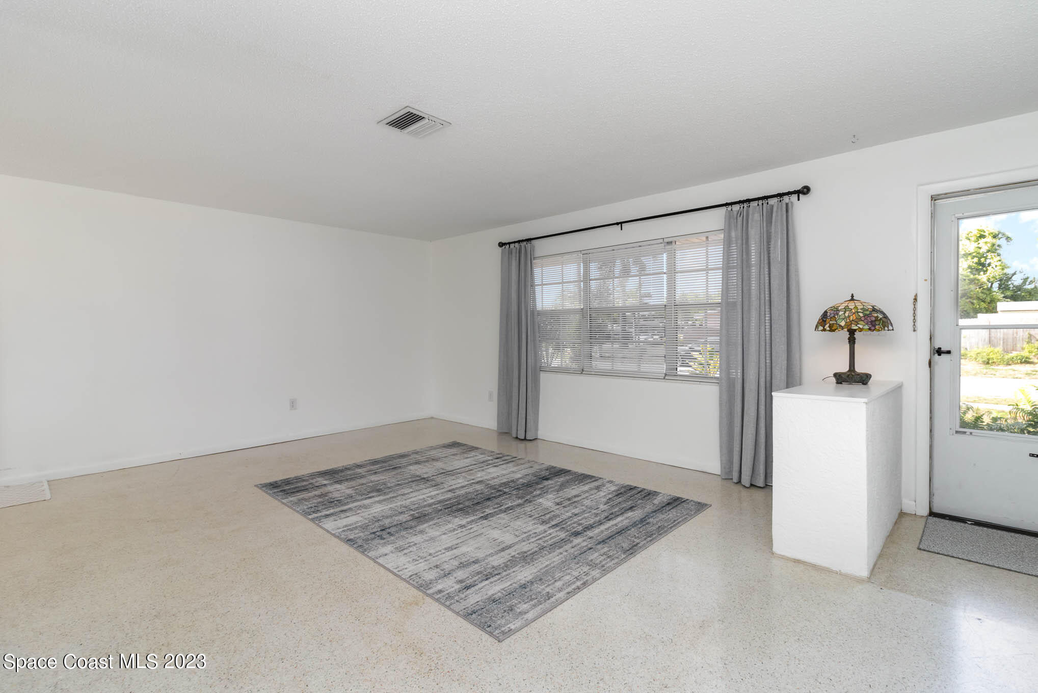2095 Montgomery Road Melbourne, FL 32935 - Photo 7 of 25 a view of an empty room and window