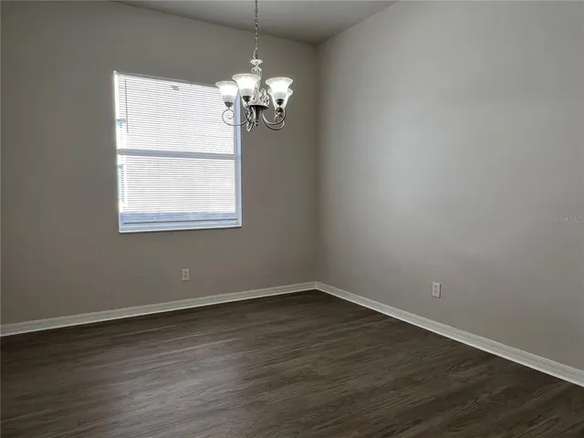 a view of wooden floor and chandelier in a room