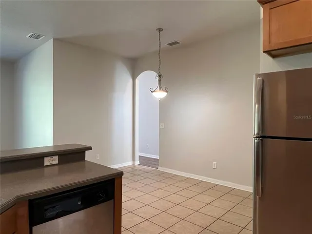 a kitchen with a refrigerator a stove and a sink