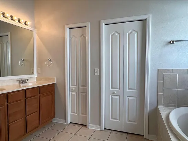a bathroom with a double vanity sink and mirror
