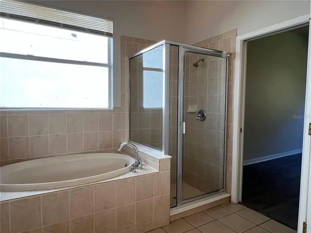 a bathroom with a bathtub and shower