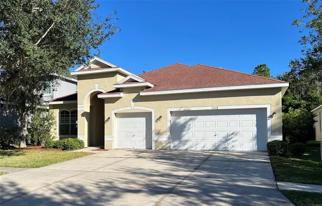 a front view of a house with a yard and garage