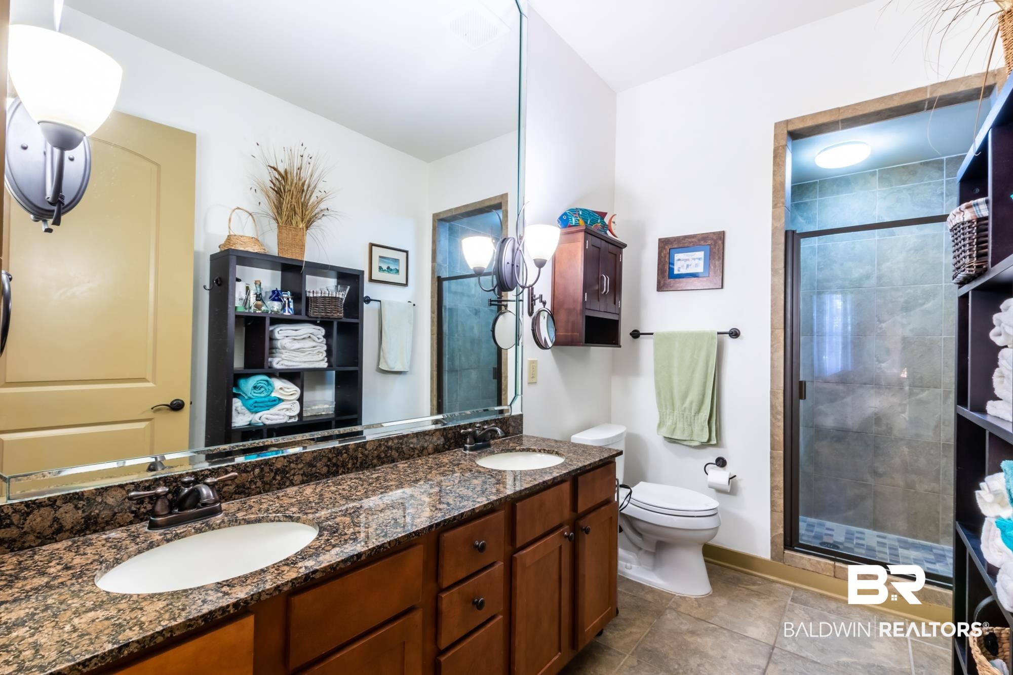 1430 Regency Road, Unit G103 Gulf Shores, AL 36542 - Photo 13 of 29 Bathroom featuring a shower with shower door, double sink, toilet, and vanity with extensive cabinet space