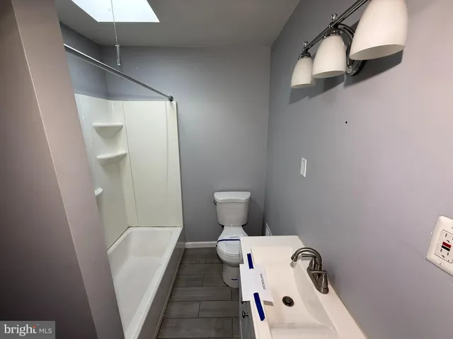 a bathroom with a toilet and a sink
