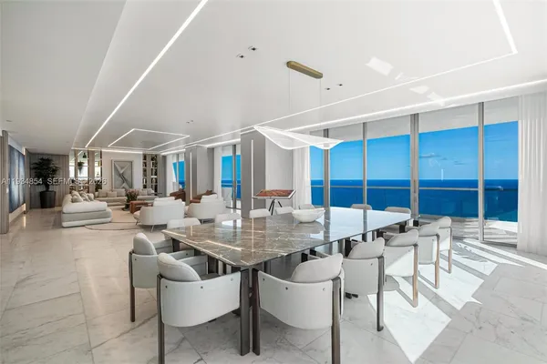 a dining room with furniture and a window