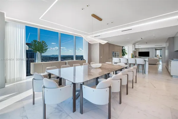 a view of a kitchen with a sink and refrigerator