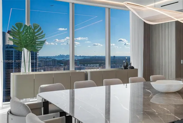 a kitchen with stainless steel appliances kitchen island granite countertop a refrigerator a stove and a sink