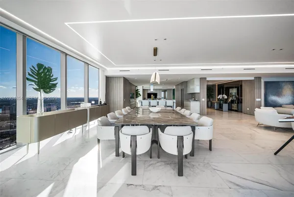 a kitchen with stainless steel appliances kitchen island granite countertop a sink and white cabinets