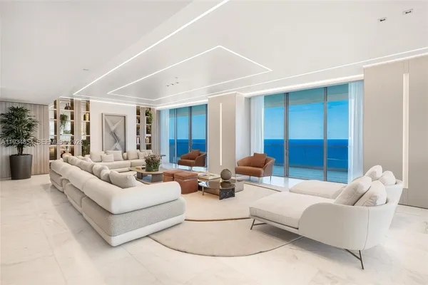 a view of a livingroom with furniture and a potted plant