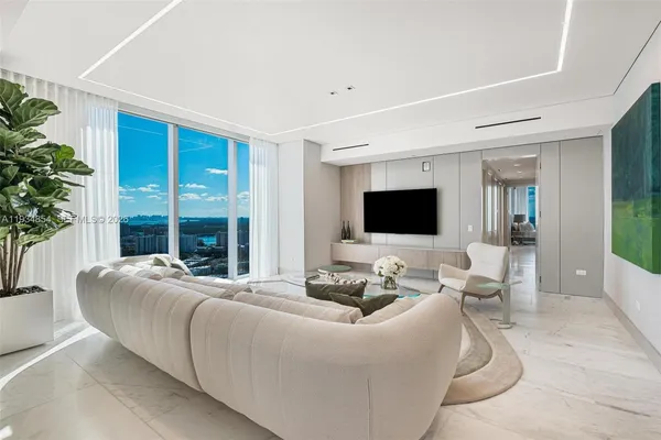 a living room with furniture and a large window