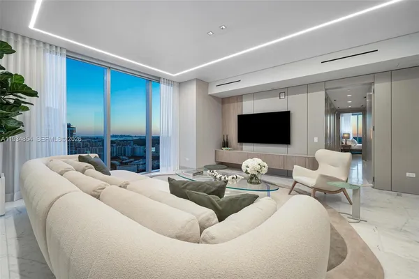 a living room with furniture and a large window