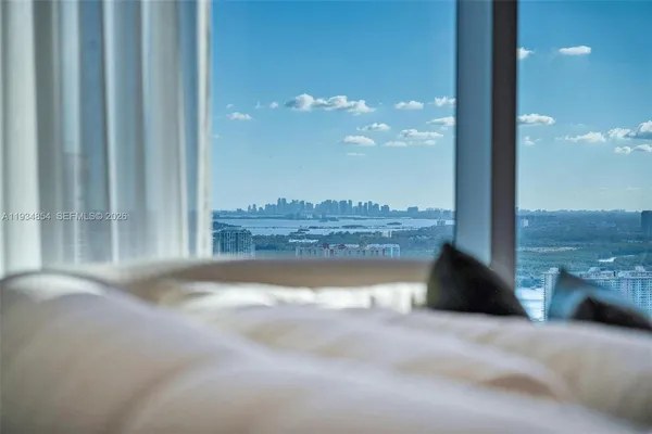 a living room with furniture and a glass door shower