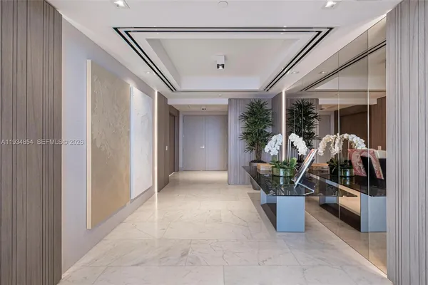 a living room with furniture potted plant and a large window