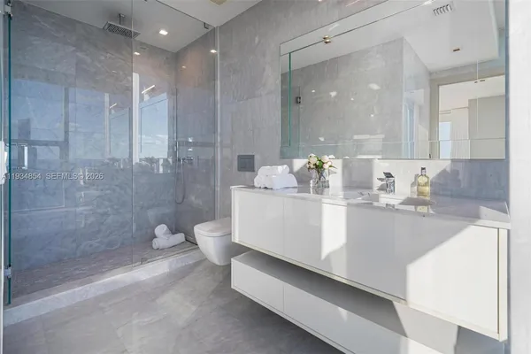 a view of a dining room with furniture one side kitchen view and a chandelier