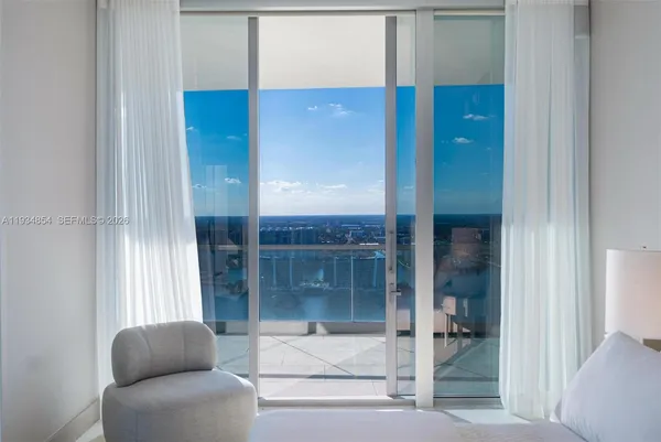 a living room with furniture and a floor to ceiling window