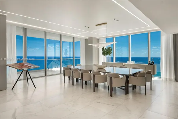 a view of a dining room with furniture and window