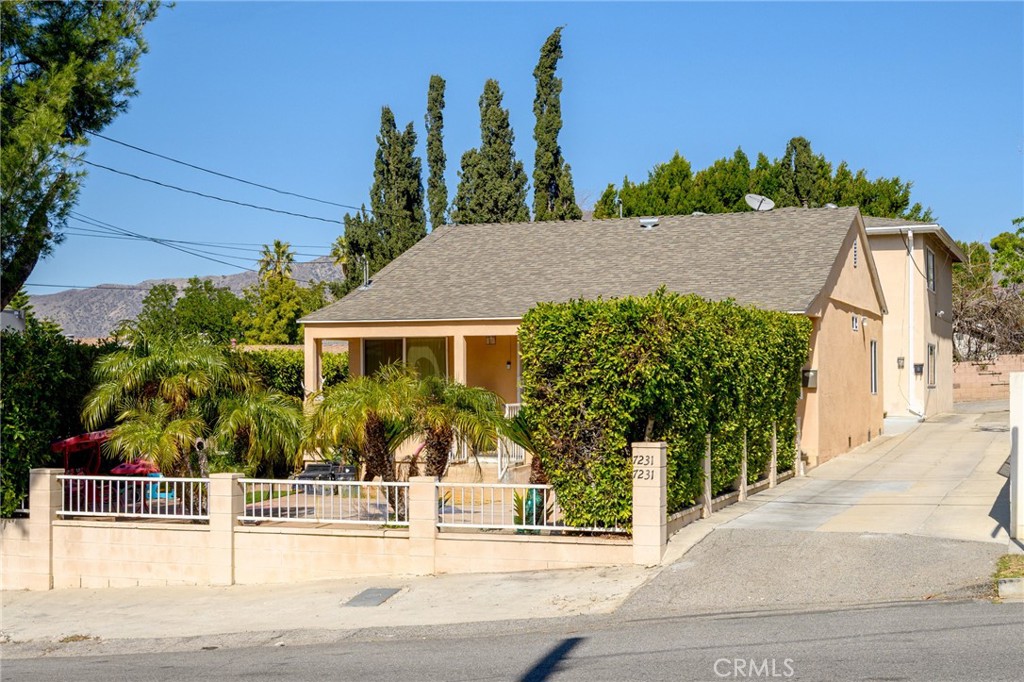 7231 Apperson Street Tujunga, CA 91042 - Photo 20 of 20 a front view of a house with a yard and potted plants