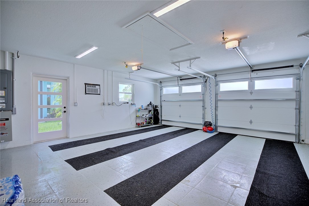 157 Loquat Road Northeast Lake Placid, FL 33852 - Photo 32 of 46 Check out the beautiful a/c garage. Epoxy flooring.