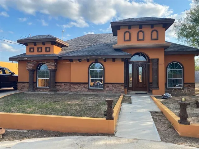 a front view of a house with garden