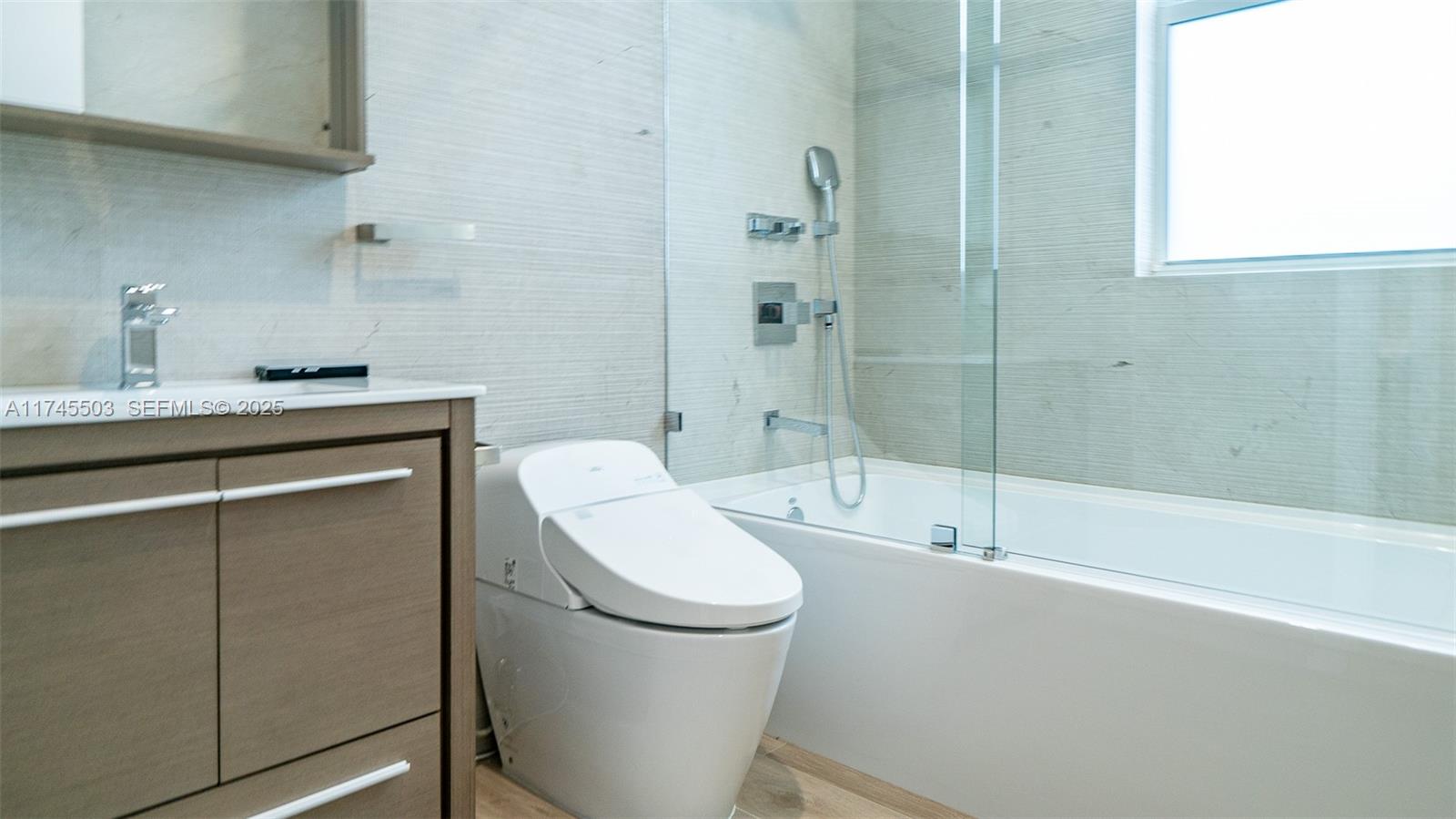 1310 Northeast 117th Terrace, Unit 2 Miami, FL 33161 - Photo 12 of 37 a bathroom with a sink a toilet and shower