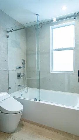 a bathroom with a toilet and a bathtub