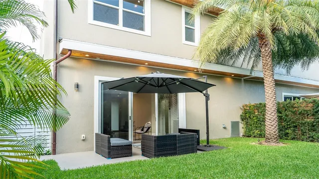 a view of house with yard and entertaining space
