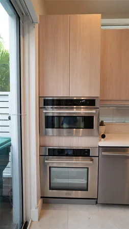 a stove top oven sitting inside of a kitchen