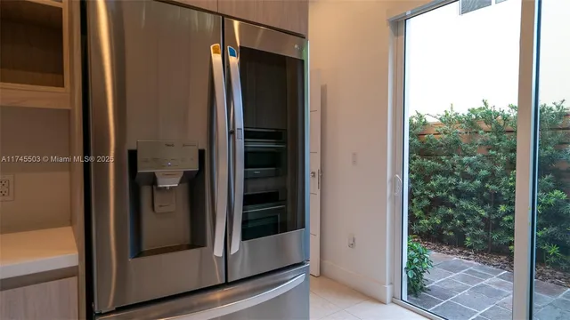 a bathroom with a glass shower door and a door