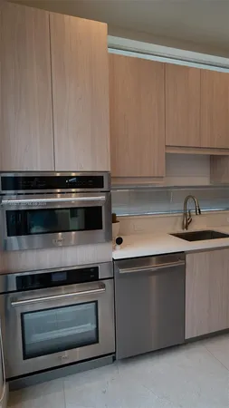 a stove top oven sitting inside of a kitchen