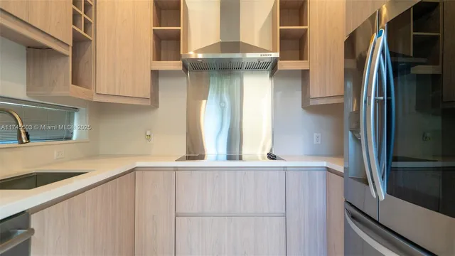 a kitchen with a refrigerator and a sink