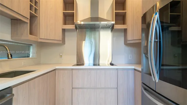 a kitchen with a refrigerator and a sink