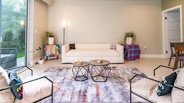 a living room with furniture and a flat screen tv