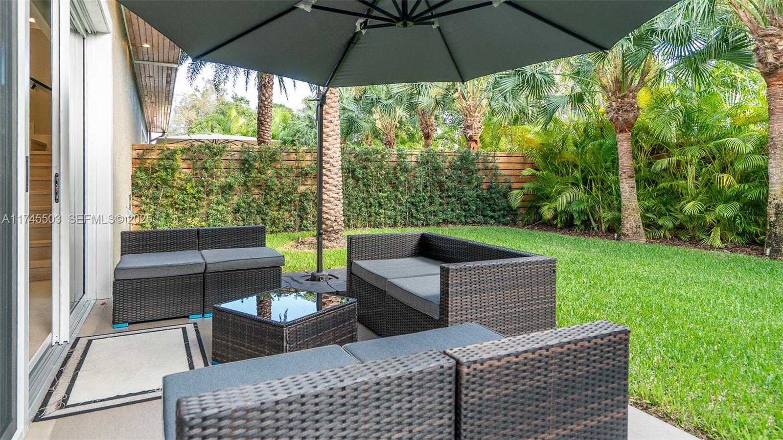 1310 Northeast 117th Terrace, Unit 2 Miami, FL 33161 - Photo 35 of 37 a view of an outdoor sitting area with a backyard