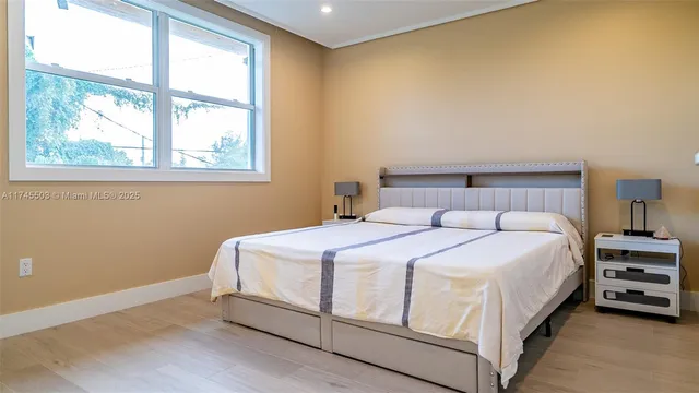 a bedroom with a bed and a window