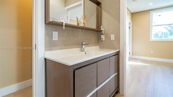 a bathroom with a sink and a mirror