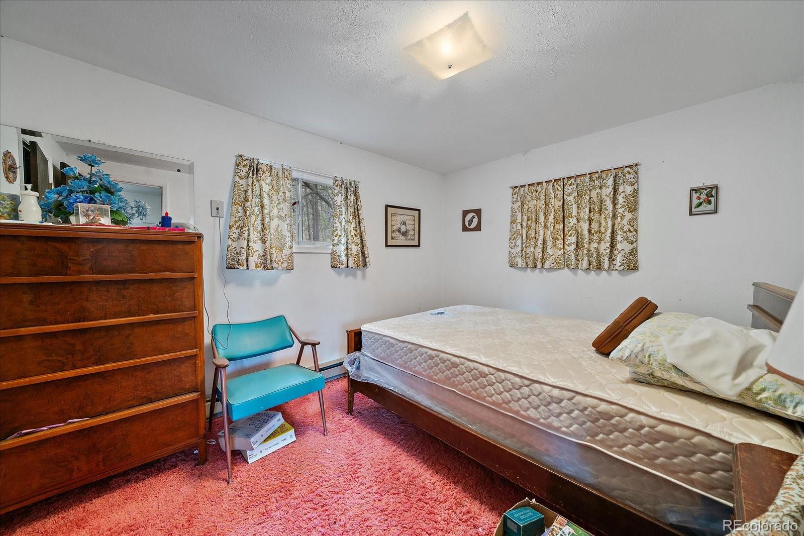118 Neish Street Bailey, CO 80421 - Photo 13 of 27 a bedroom with a bed and wooden floor