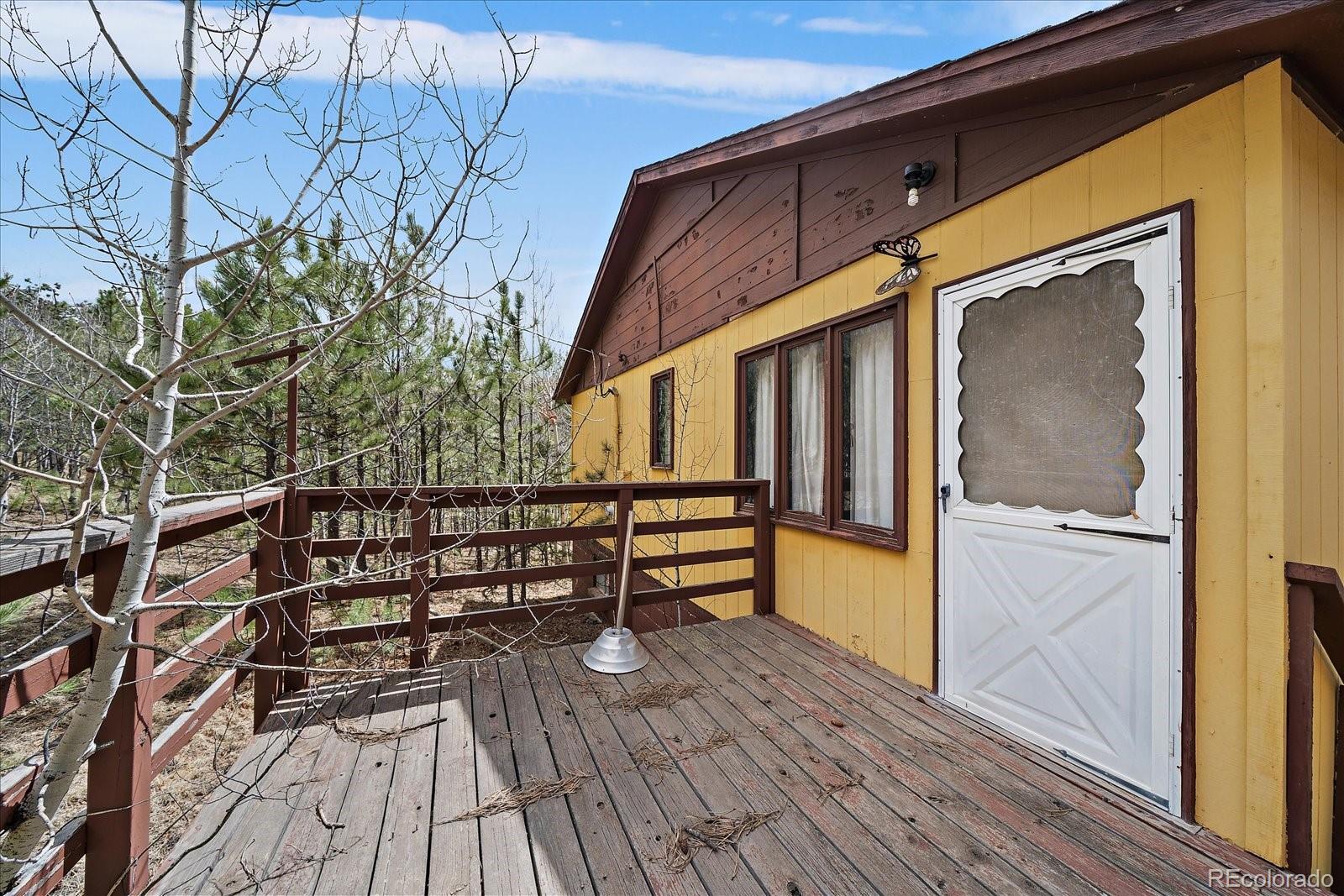 118 Neish Street Bailey, CO 80421 - Photo 6 of 27 a view of entryway with wooden floor and fence
