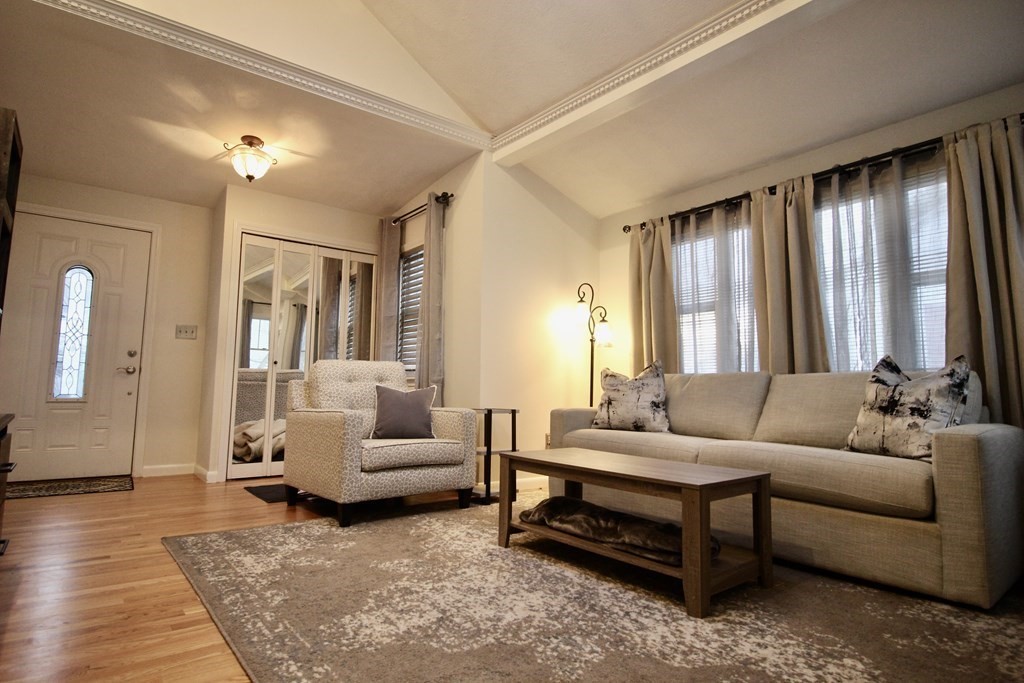 133 Hardy Pond Road Waltham, MA 02451 - Photo 2 of 30 a living room with furniture and a large window