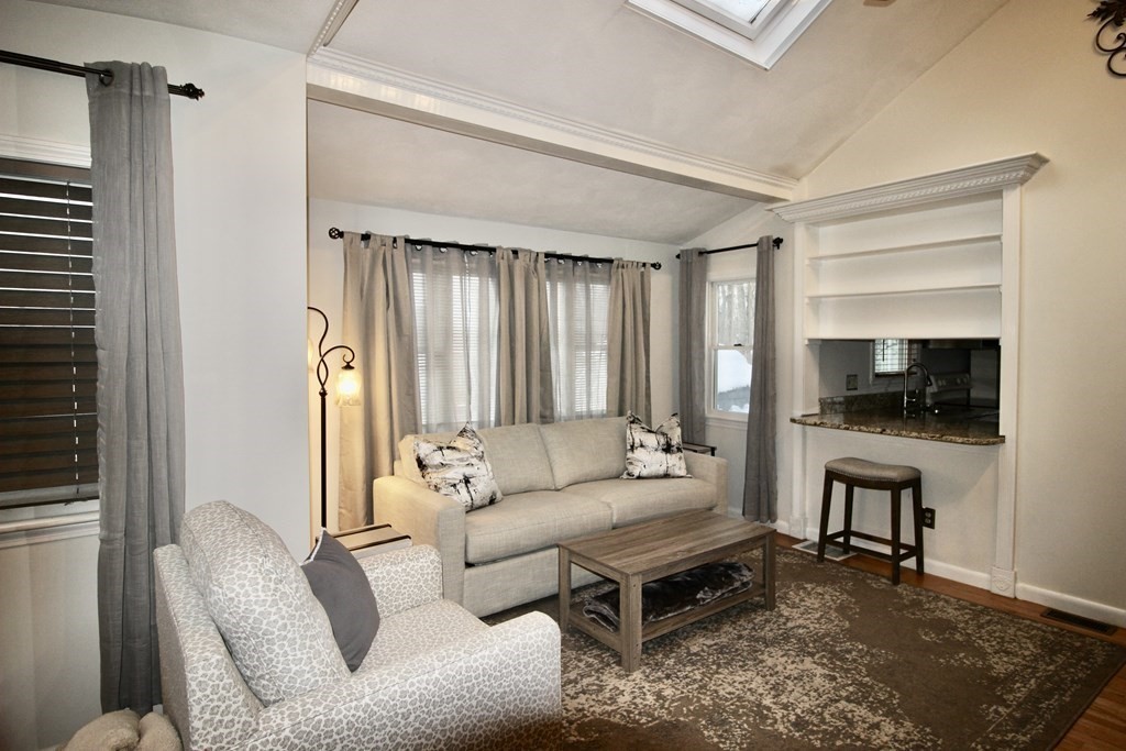 133 Hardy Pond Road Waltham, MA 02451 - Photo 3 of 30 a living room with furniture flat screen tv and a window