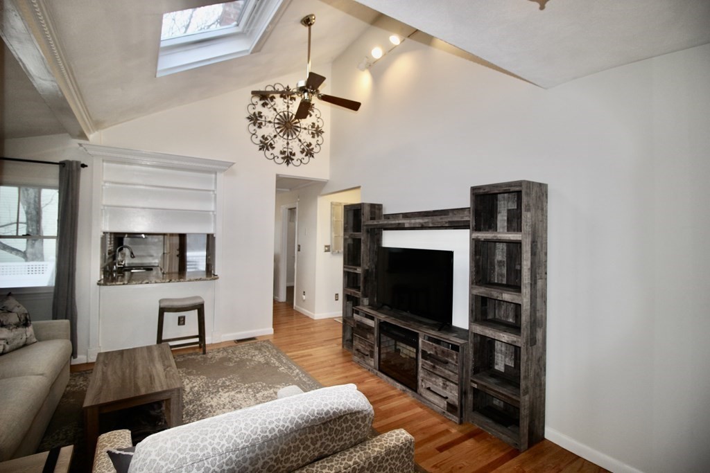 133 Hardy Pond Road Waltham, MA 02451 - Photo 4 of 30 a living room with furniture and a flat screen tv
